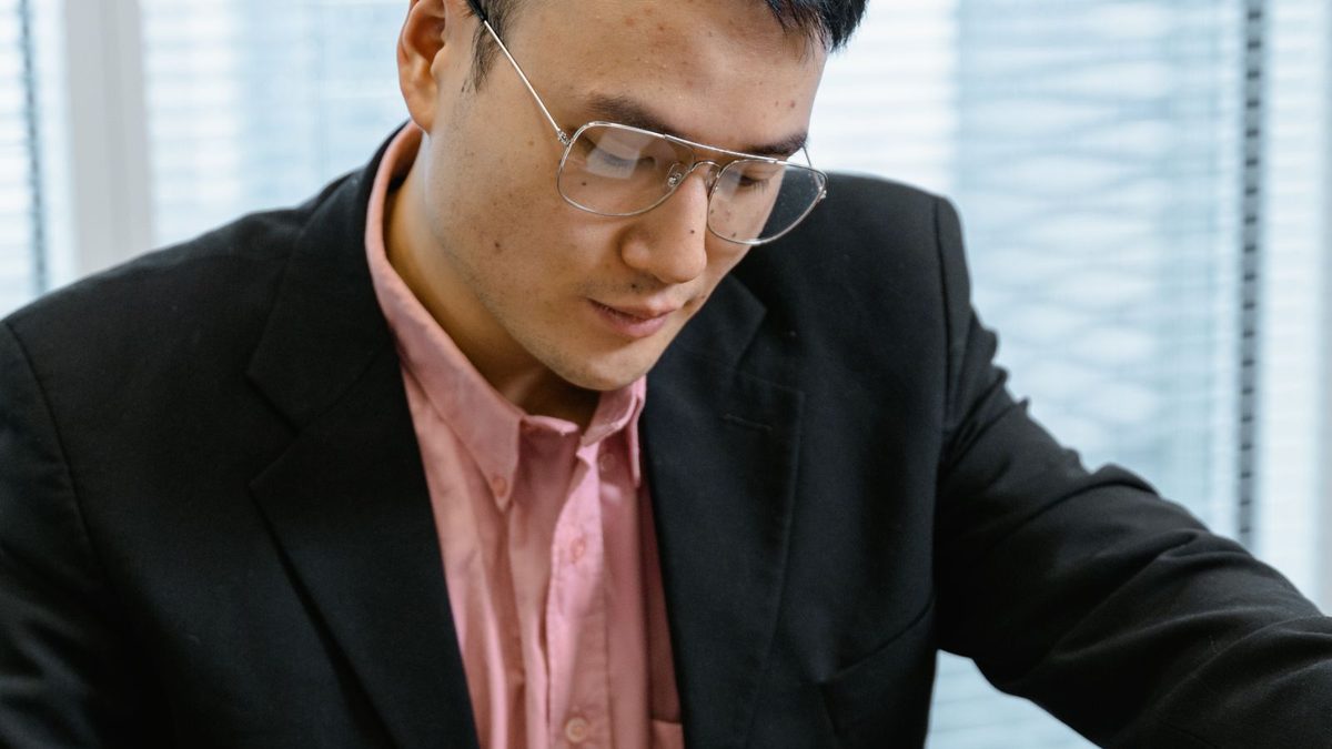 Migrant reviewing papers before a Chinese to English translation for an Australian visa